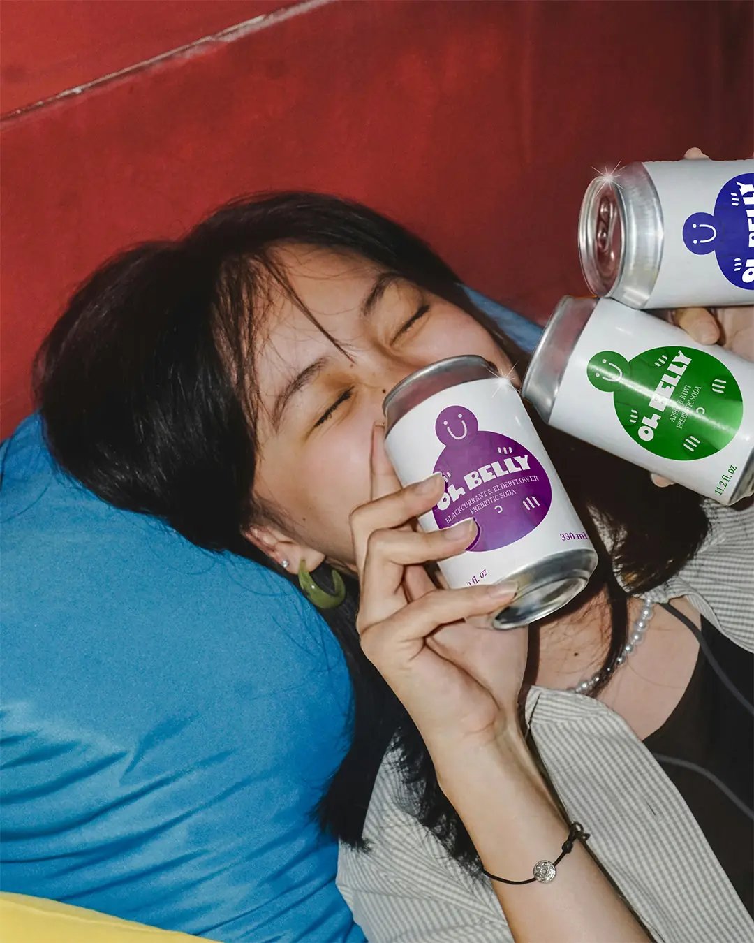 Oh Belly - Woman Posing with 3 Cans