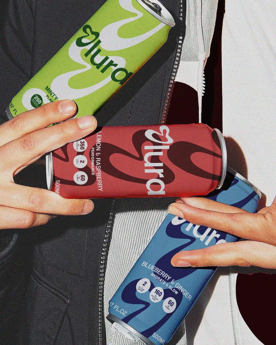 Olura Cans Held in Hands