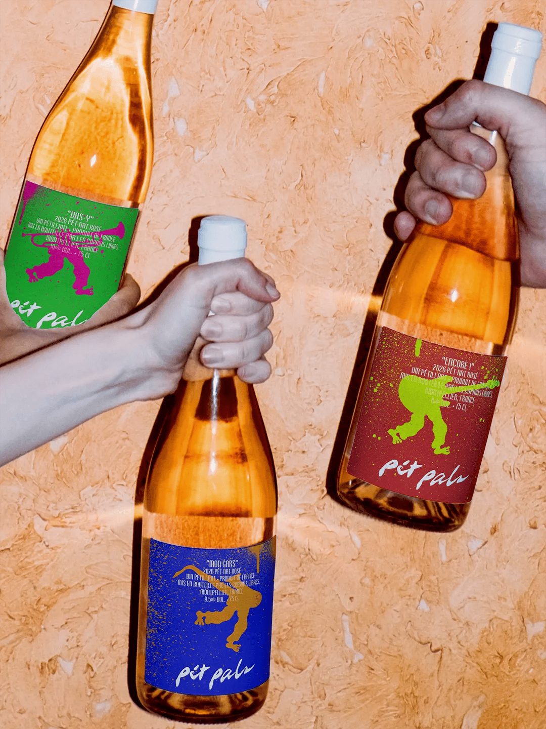 Pét Pals bottles held against wall