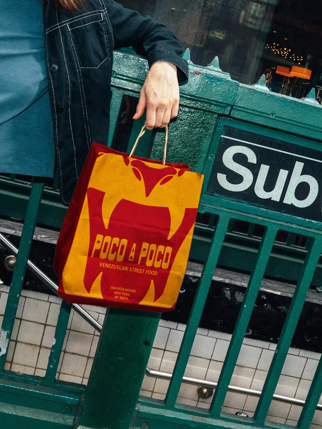 Poco A Poco takeaway bag infront of subway entrance