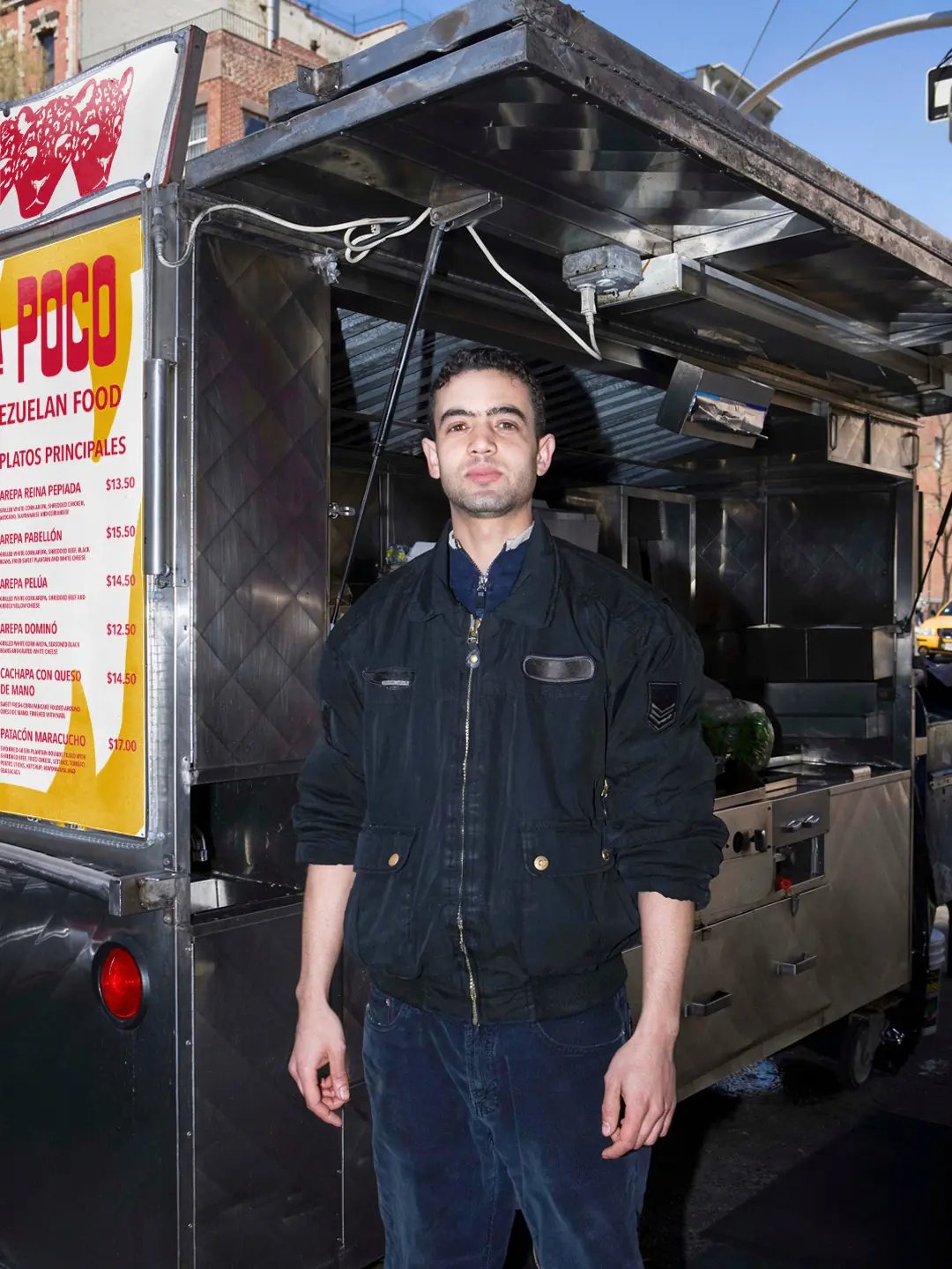 Poco A Poco employee infront of truck with sign and menu