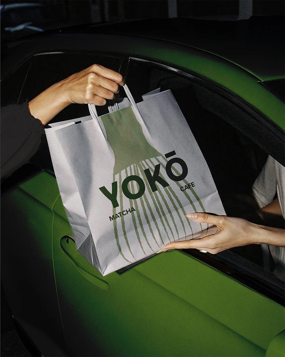 YOKŌ Bag Being Passed Into Car